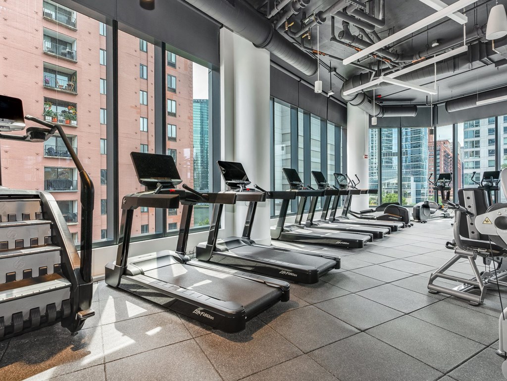 a row of treadmills in a fitness room with a view of the city  at Cassidy on Canal, Chicago, Illinois