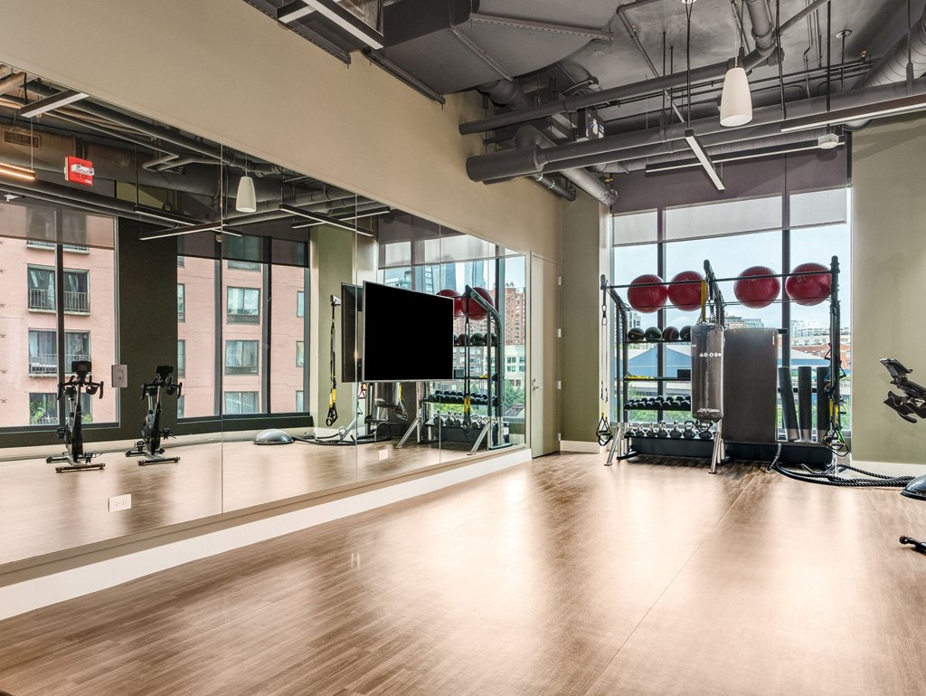 a workout room with a large window and gym equipment  at Cassidy on Canal, Chicago