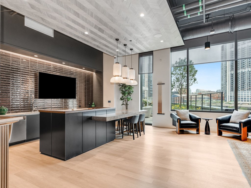 a kitchen and living room with a large window and a tv at Cassidy on Canal, Chicago, Illinois