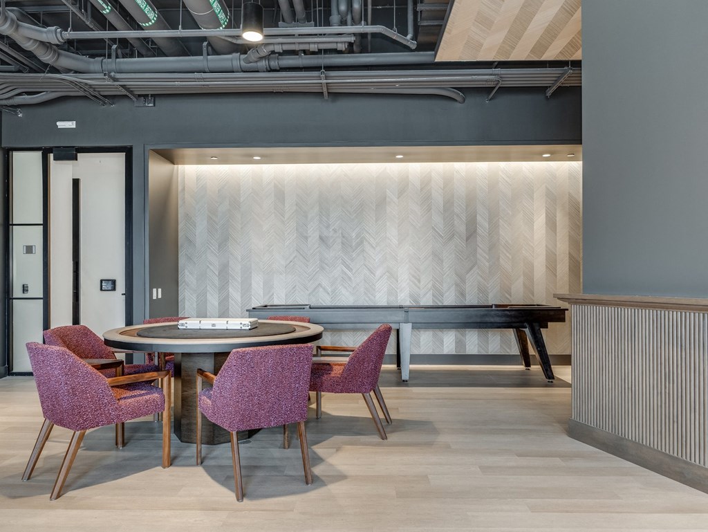 a table and chairs in a room with a piano  at Cassidy on Canal, Chicago
