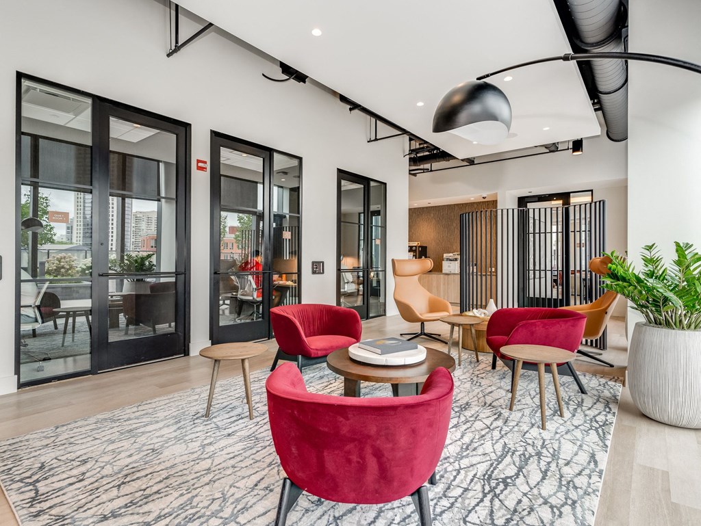 a living room with red chairs and a table  at Cassidy on Canal, Chicago, Illinois