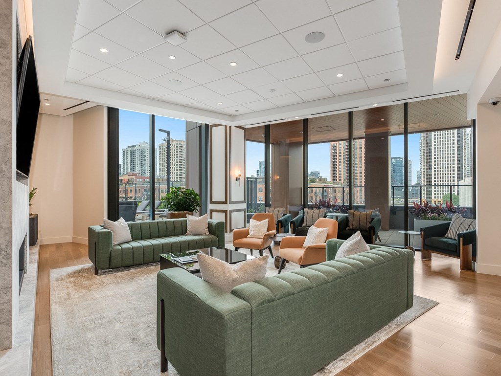 a living room with couches and chairs in front of windows  at Cassidy on Canal, Chicago