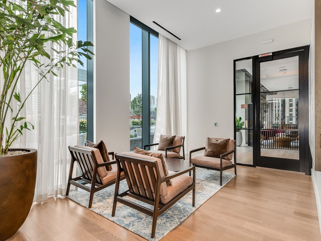 a living room with chairs and a table and sliding glass doors  at Cassidy on Canal, Chicago, Illinois