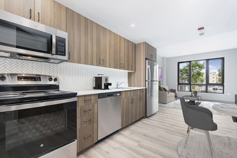 A modern kitchen with wooden cabinets and stainless steel appliances.