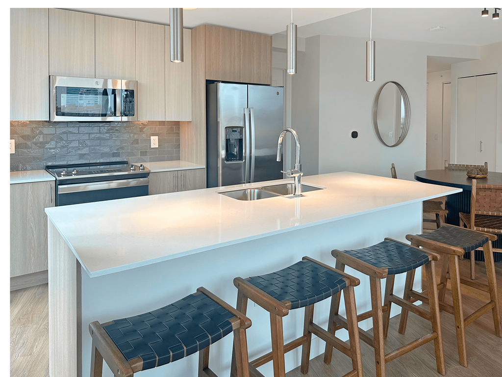 a kitchen with a large island with bar stools at Cassidy on Canal, IL, 60654