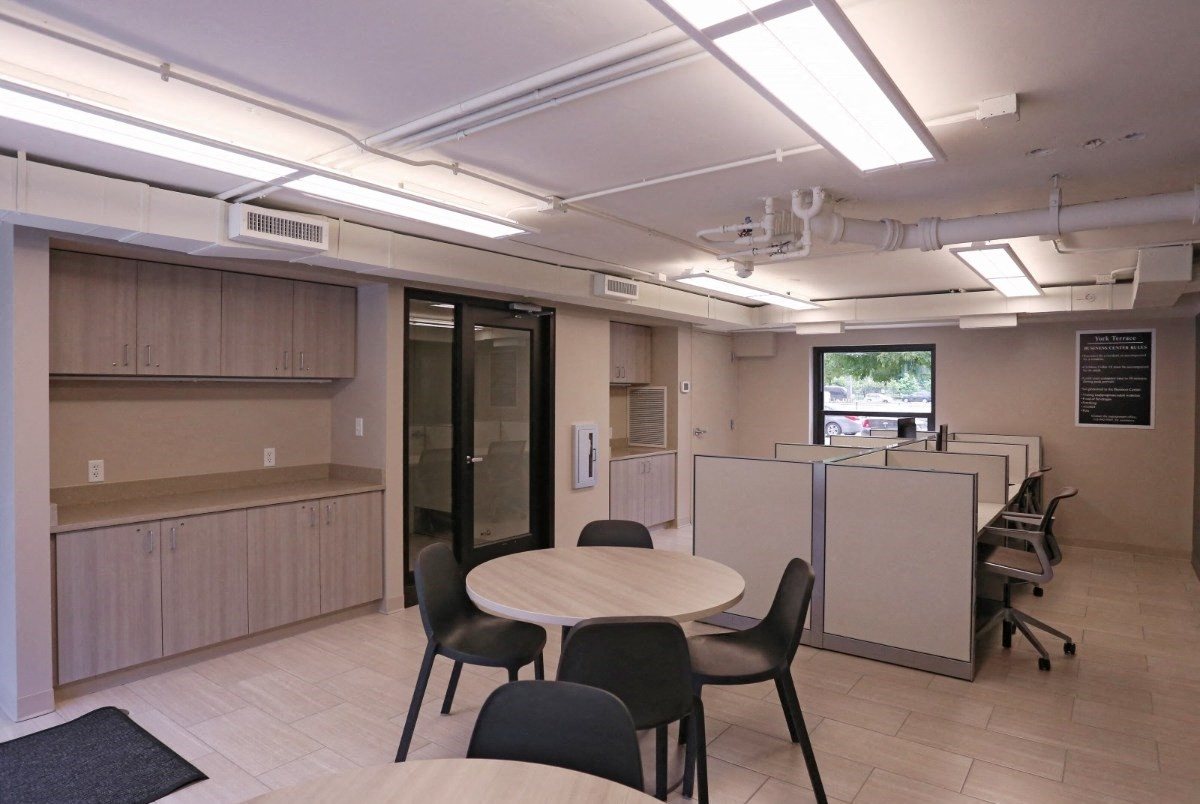 Resident Business Center with tables, seating, and window at Eden Commons, Illinois