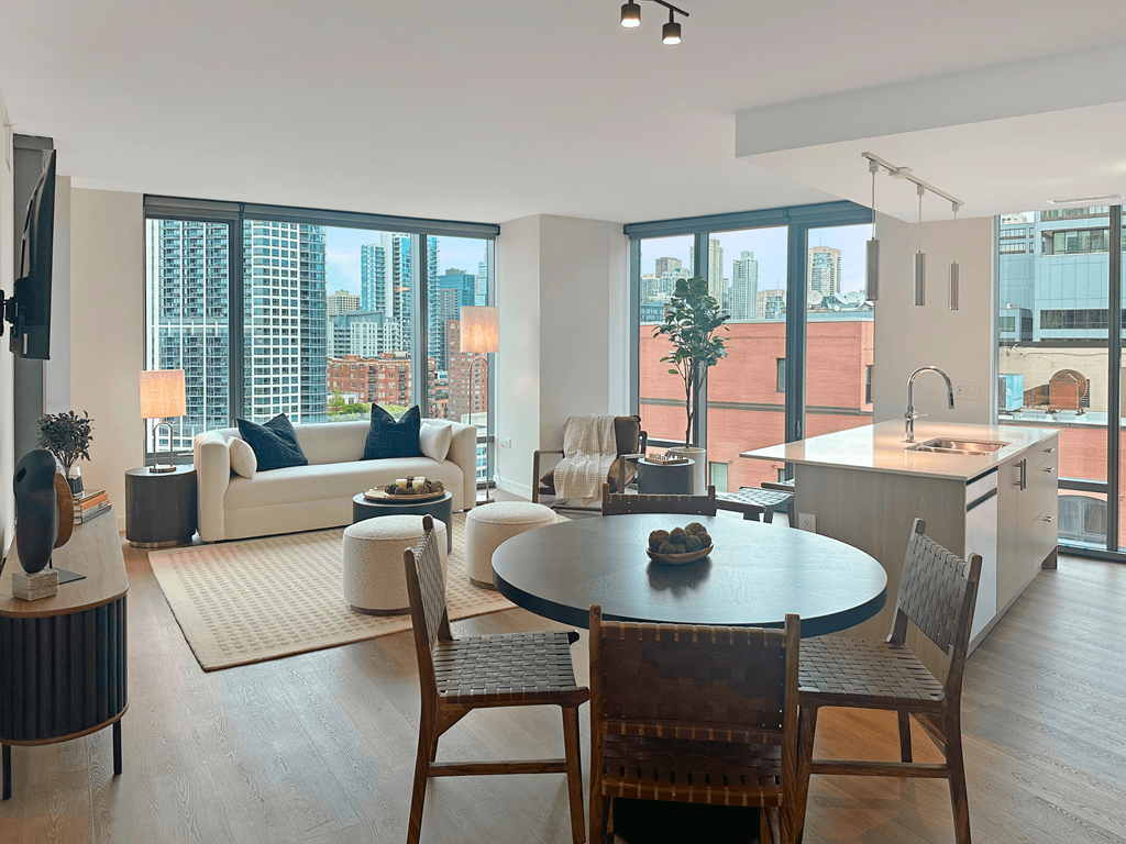 a living room and dining room with a view of the city at Cassidy on Canal, Chicago, 60654