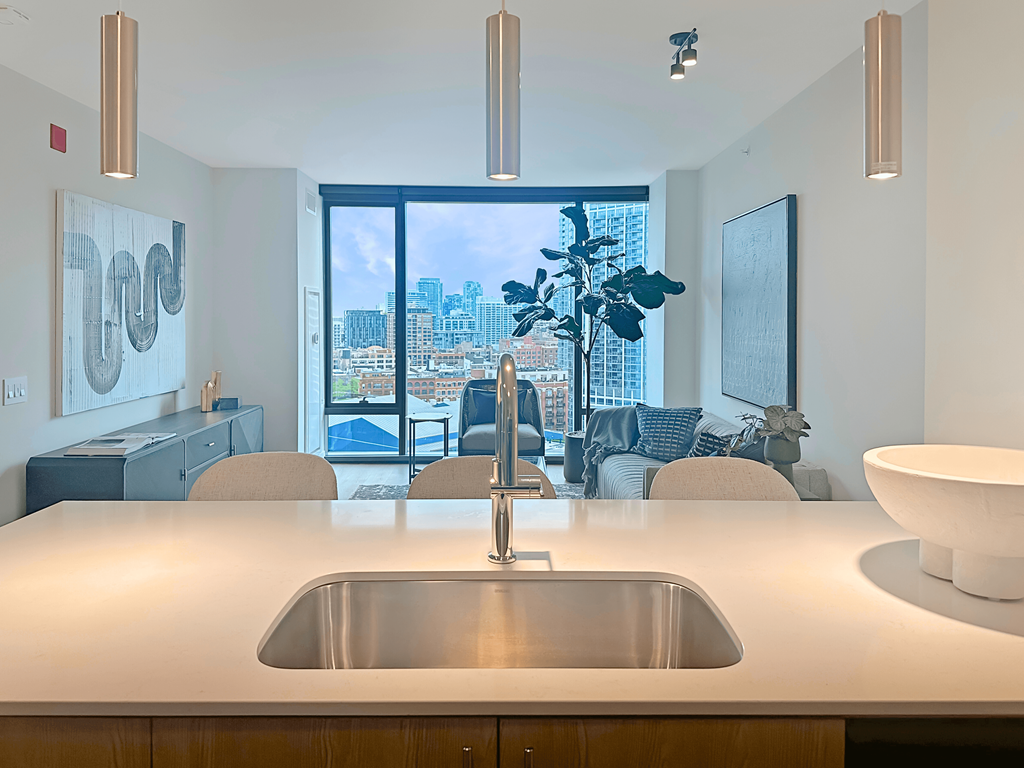 a kitchen counter with a sink and a view of the city at Cassidy on Canal, Chicago