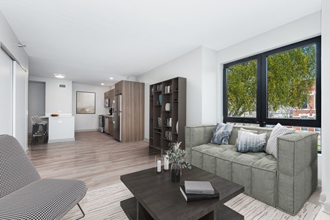 A modern living room with a grey sofa and a black coffee table.