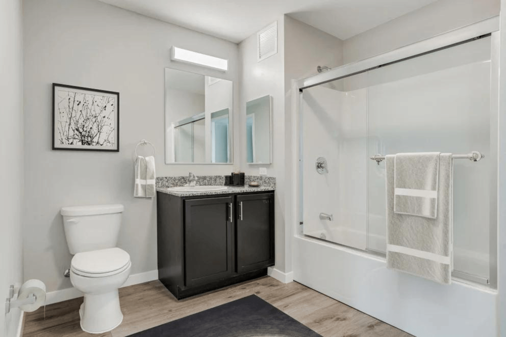 a bathroom with a sink toilet and a shower
