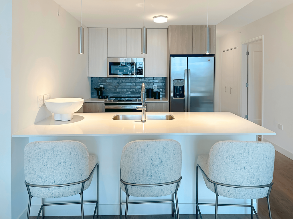 a kitchen with a counter top and three chairs at Cassidy on Canal, IL