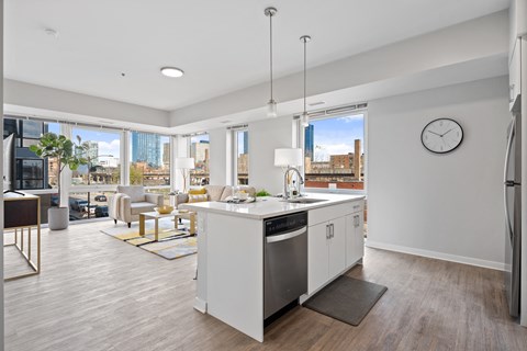 A modern kitchen with white cabinets and a large island.