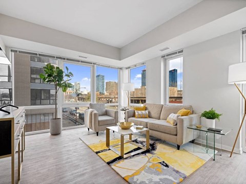 a living room with a couch and a view of the city