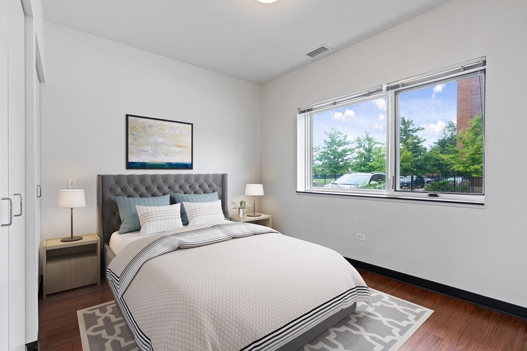 a bedroom with a large window and a bed