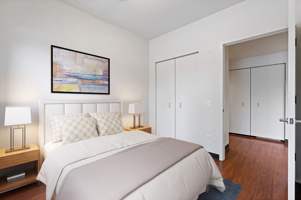 a bedroom with a bed and a painting on the wall