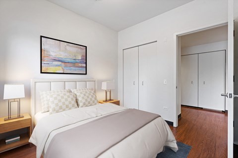 a bedroom with a bed and a painting on the wall