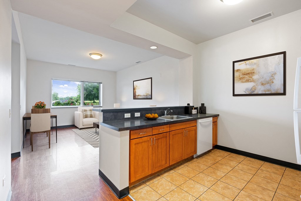 a large kitchen with a sink and a counter top