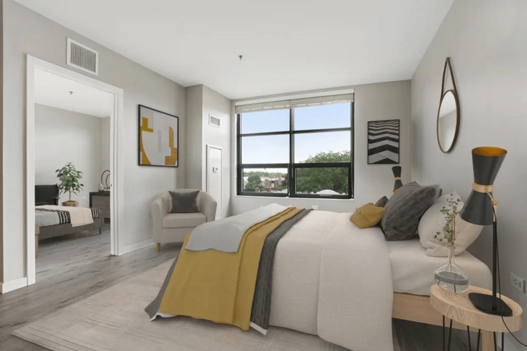 a bedroom with a large bed and a window