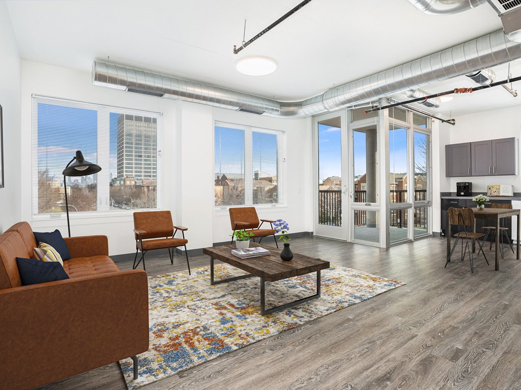 a living room with a couch and chairs and a coffee table