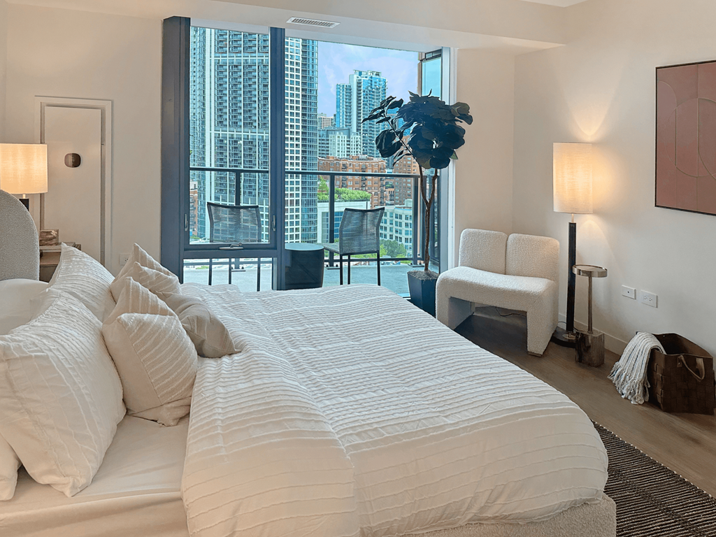 a bedroom with a large bed and a large window at Cassidy on Canal, Chicago, 60654