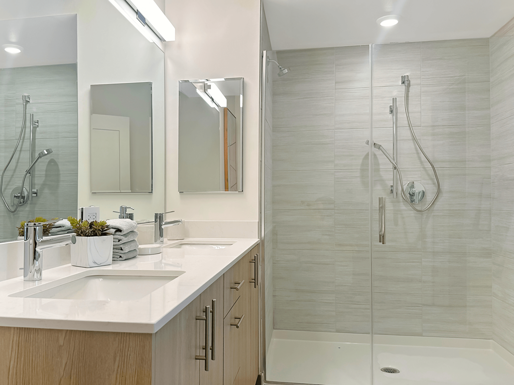 a bathroom with two sinks and a shower at Cassidy on Canal, Chicago, IL