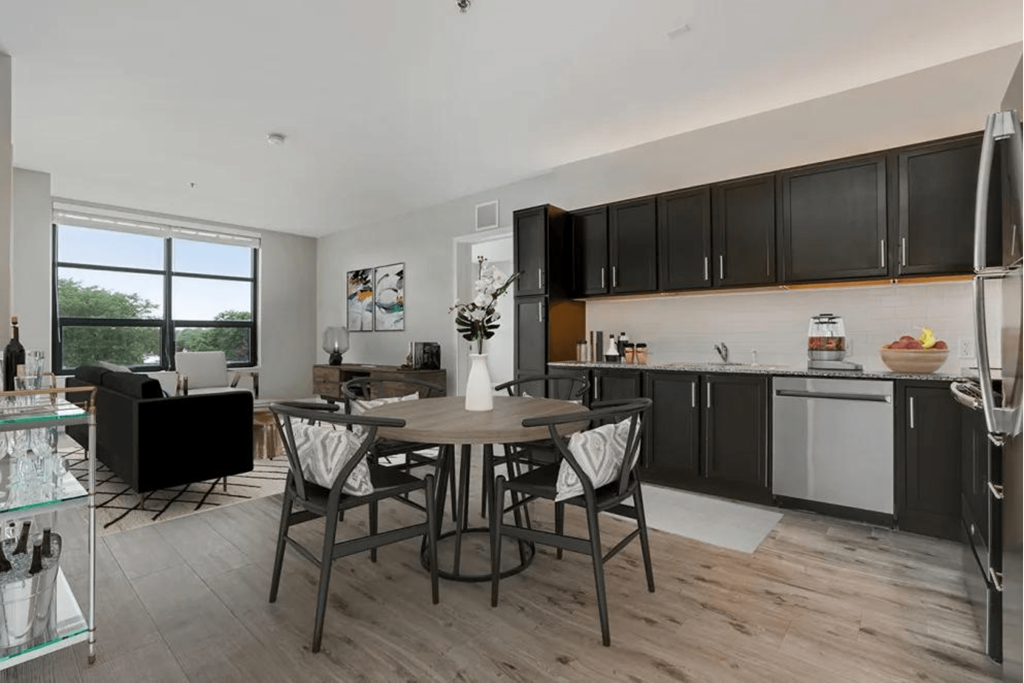 a kitchen and dining room with a table and chairs