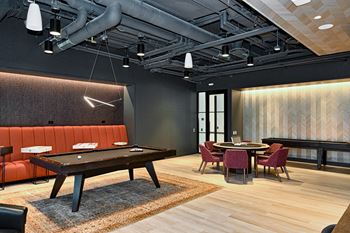 a large room with a pool table and tables and chairs  at Cassidy on Canal, Chicago