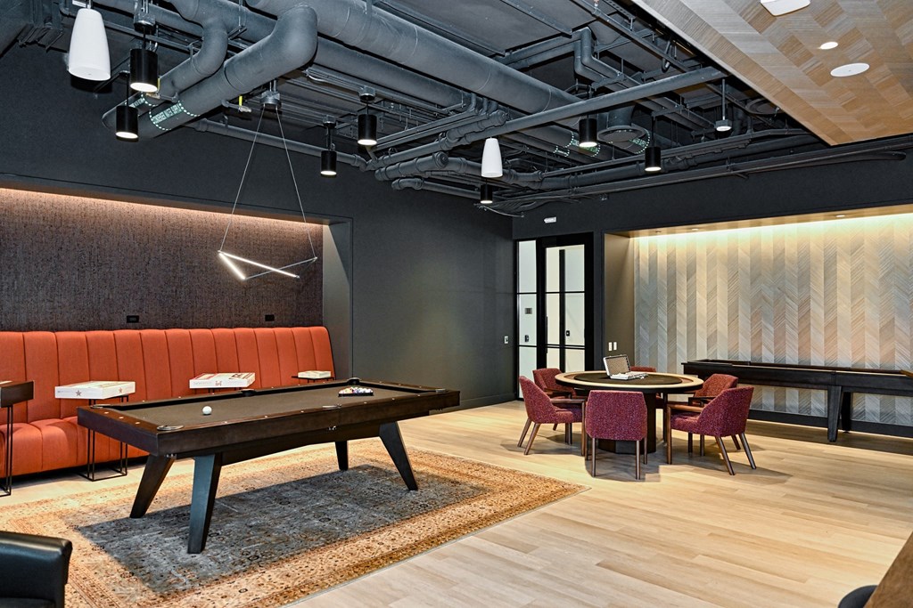 a large room with a pool table and tables and chairs