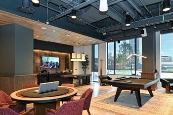 a lounge area with a pool table and a tv  at Cassidy on Canal, Illinois