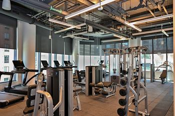 a gym with cardio equipment and windows in a building  at Cassidy on Canal, Chicago, Illinois
