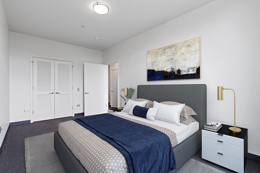 a bedroom with a bed and a painting on the wall