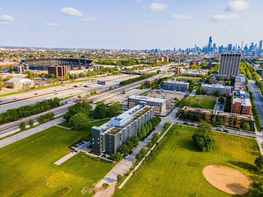 an aerial view of the campus with the chicago skyline in the background