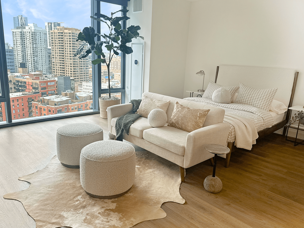 a bedroom with a couch and a bed and a view of the city at Cassidy on Canal, Chicago, IL, 60654