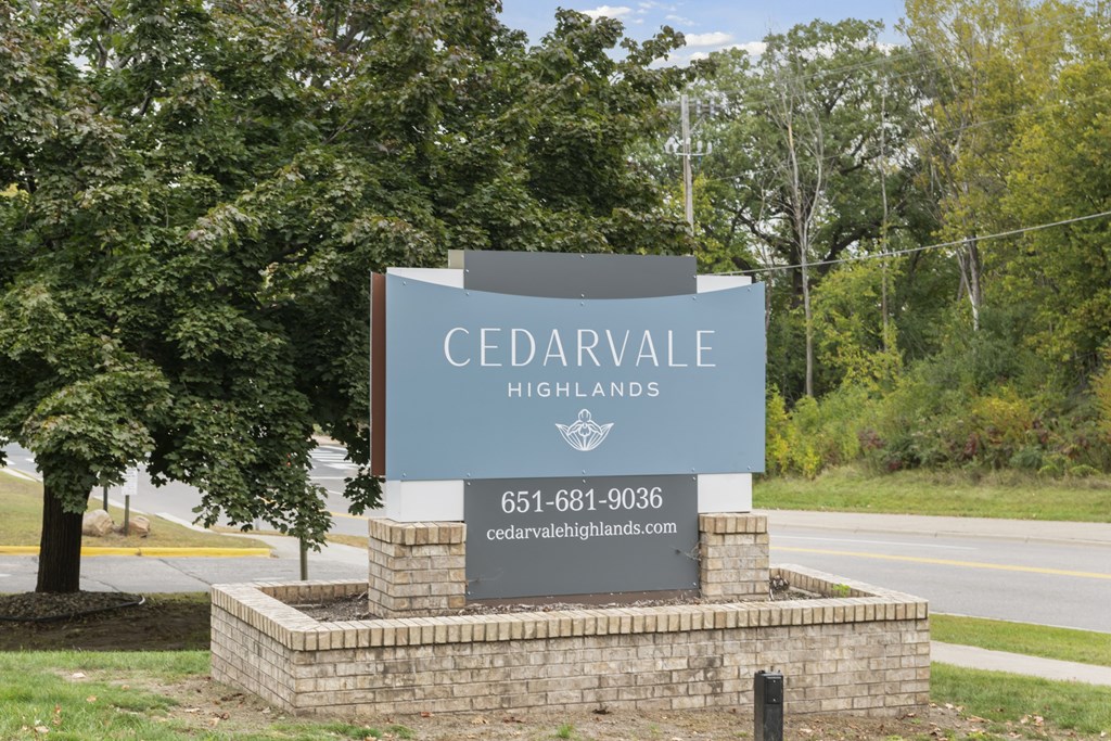 A sign for Cedarvale Highlands with a phone number and website.