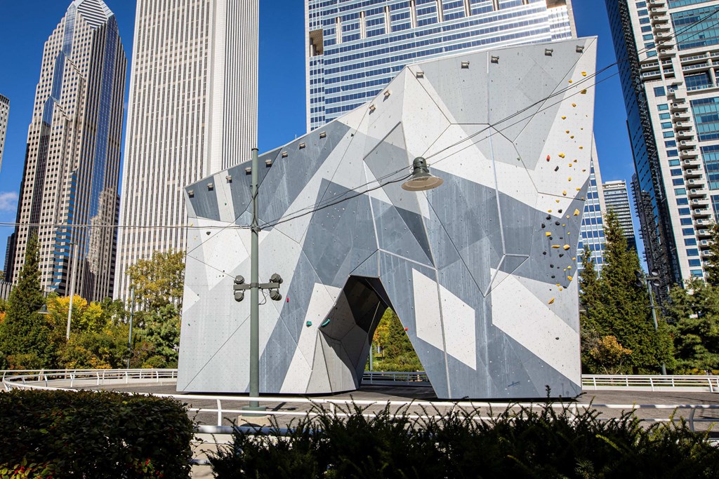 a triangular building in a city with tall skyscrapers at Columbus Plaza, Chicago, IL