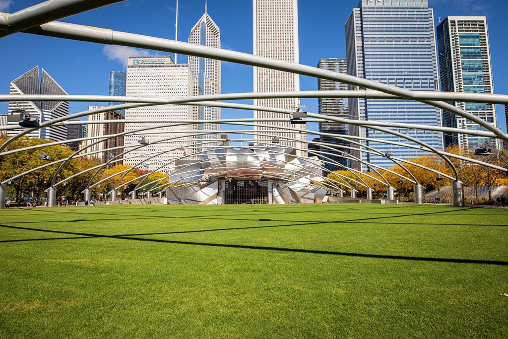 a park in the city with skyscrapers in the background at Columbus Plaza, Illinois