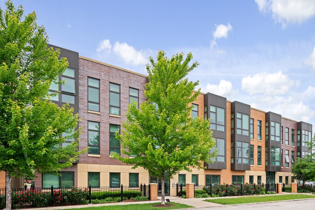 a brick building with trees in front of it