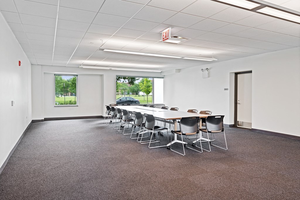 a conference room with a long table and chairs
