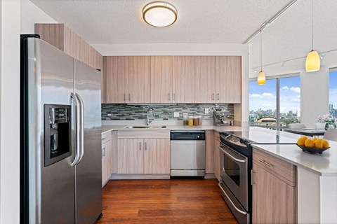 a kitchen with stainless steel appliances and wooden cabinets