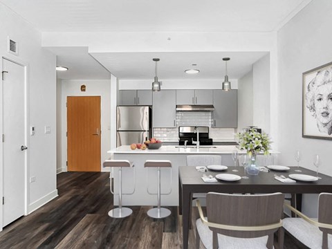 an open kitchen and dining area with a table and chairs