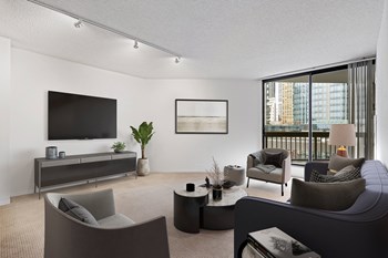 River North apartment rental living room at Asbury Plaza featuring a private balcony with views of Chicago - Photo Gallery 4