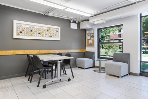 a seating area with a table and chairs at Eden Commons, Chicago, IL
