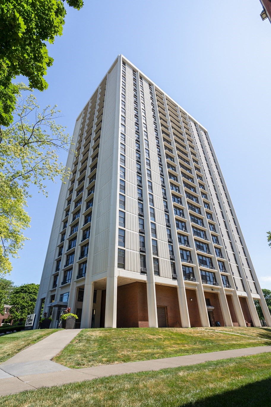 a tall building with many windows and a sidewalk in front of it at Eden Commons, Illinois, 60616