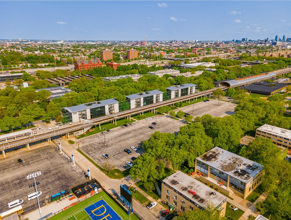 A view of a city from above, with a basketball court in the foreground.