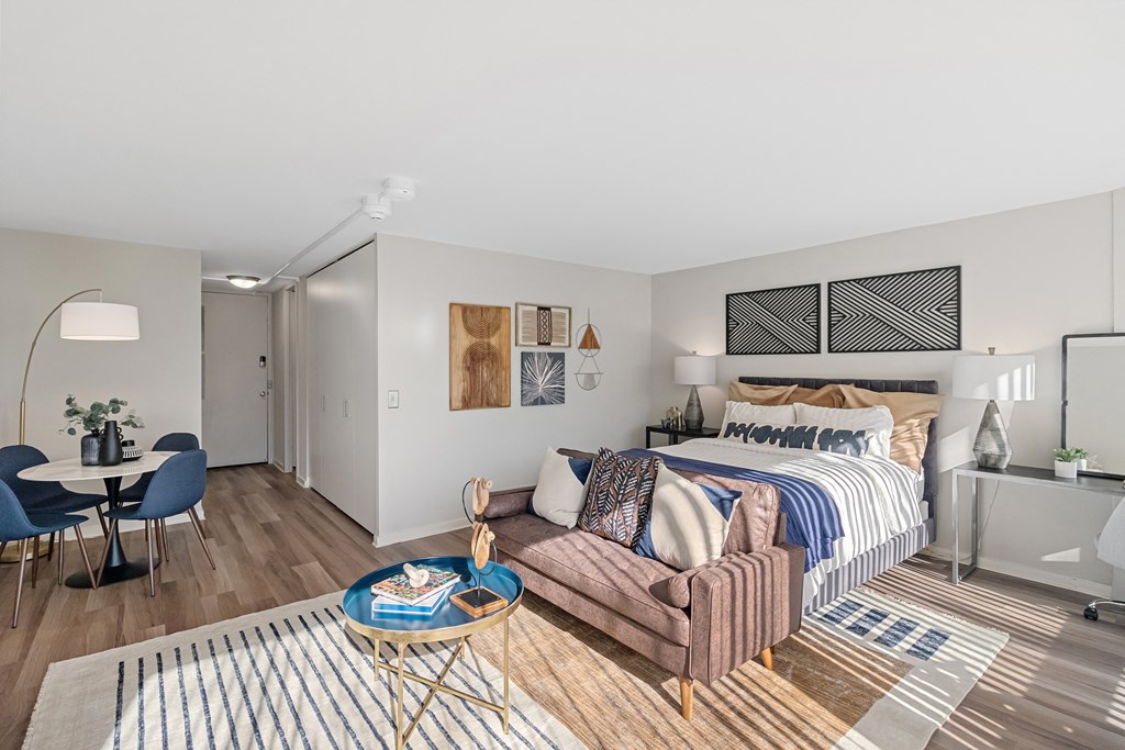 a living room with a bed and a couch  at The Pavilion, Detroit, MI, 48207