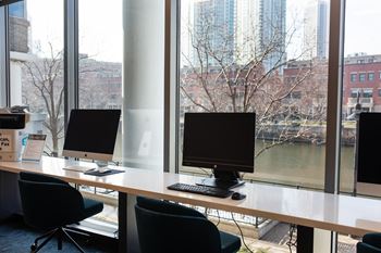 a desk with three computer monitors on top of it