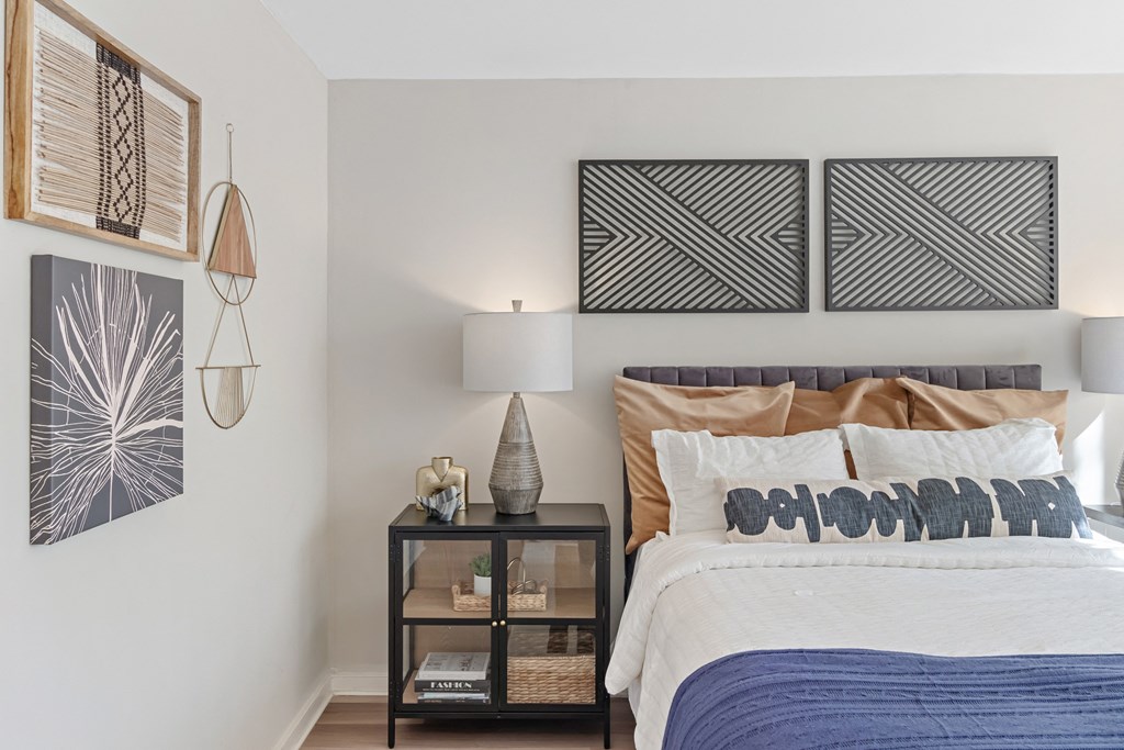 a bedroom with a bed and paintings on the wall at The Pavilion, Michigan, 48207