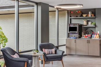 Sitting area and coffee station with floor to ceiling windows at The Waverly - Photo Gallery 6
