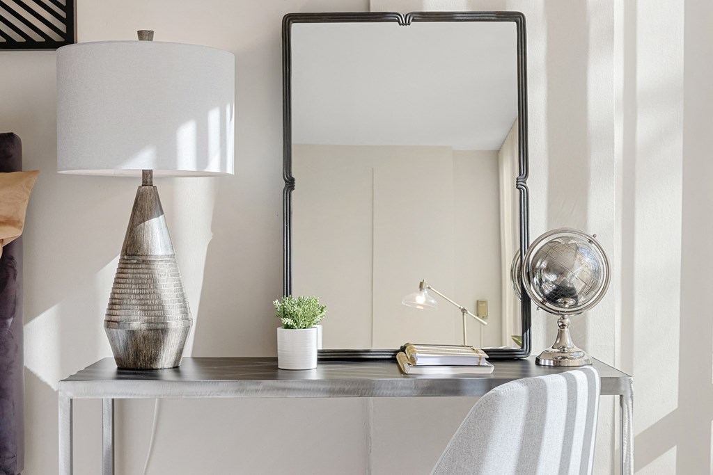 a desk with a mirror and a lamp on it at The Pavilion, Detroit, Michigan