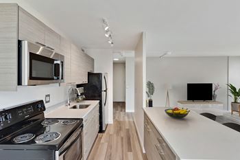 a kitchen and living room in a 555 waverly unit